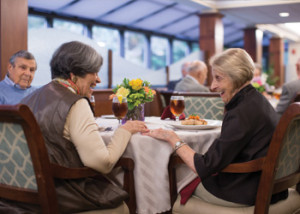 Three seniors talking and having dinner together