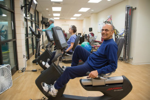A senior man exercising on a Lifecycle at Whitney Center's state-of-the-art fitness center