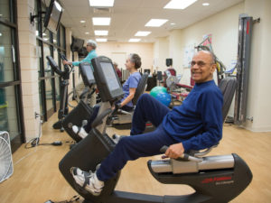 A senior man exercising on a Lifecycle at Whitney Center's state-of-the-art fitness center