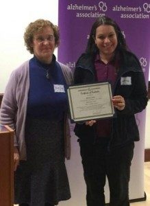 Wanda Avila shows an award she received from the Alzheimer's Association for her work as Whitney Center's Memory Support Coordinator