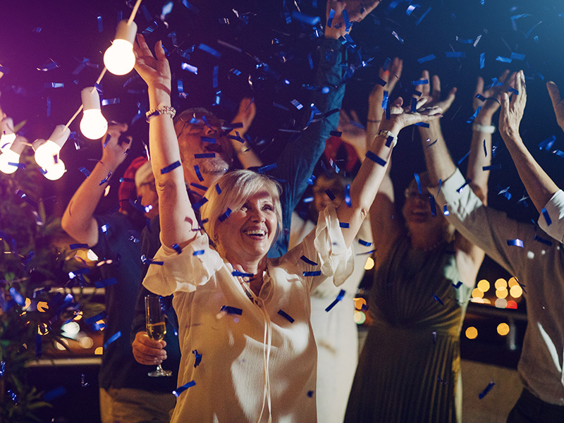 Group of senior friends dancing on New Year's party.